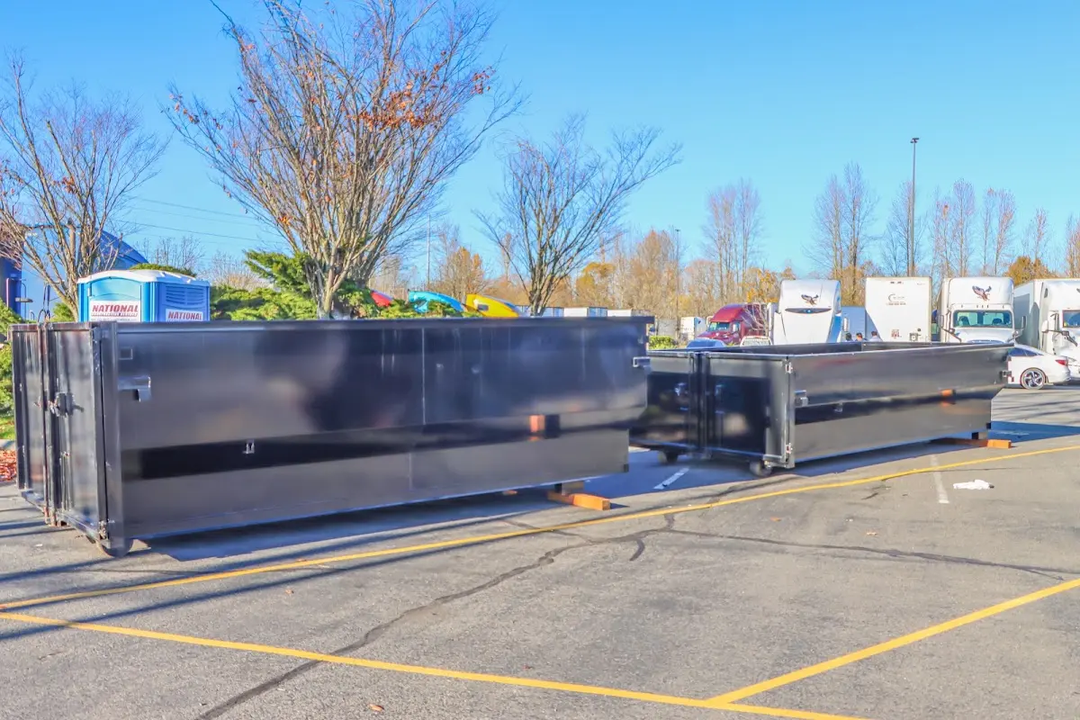 Professional dumpster rental service with roll-off container on residential driveway in Eucalyptus Hills